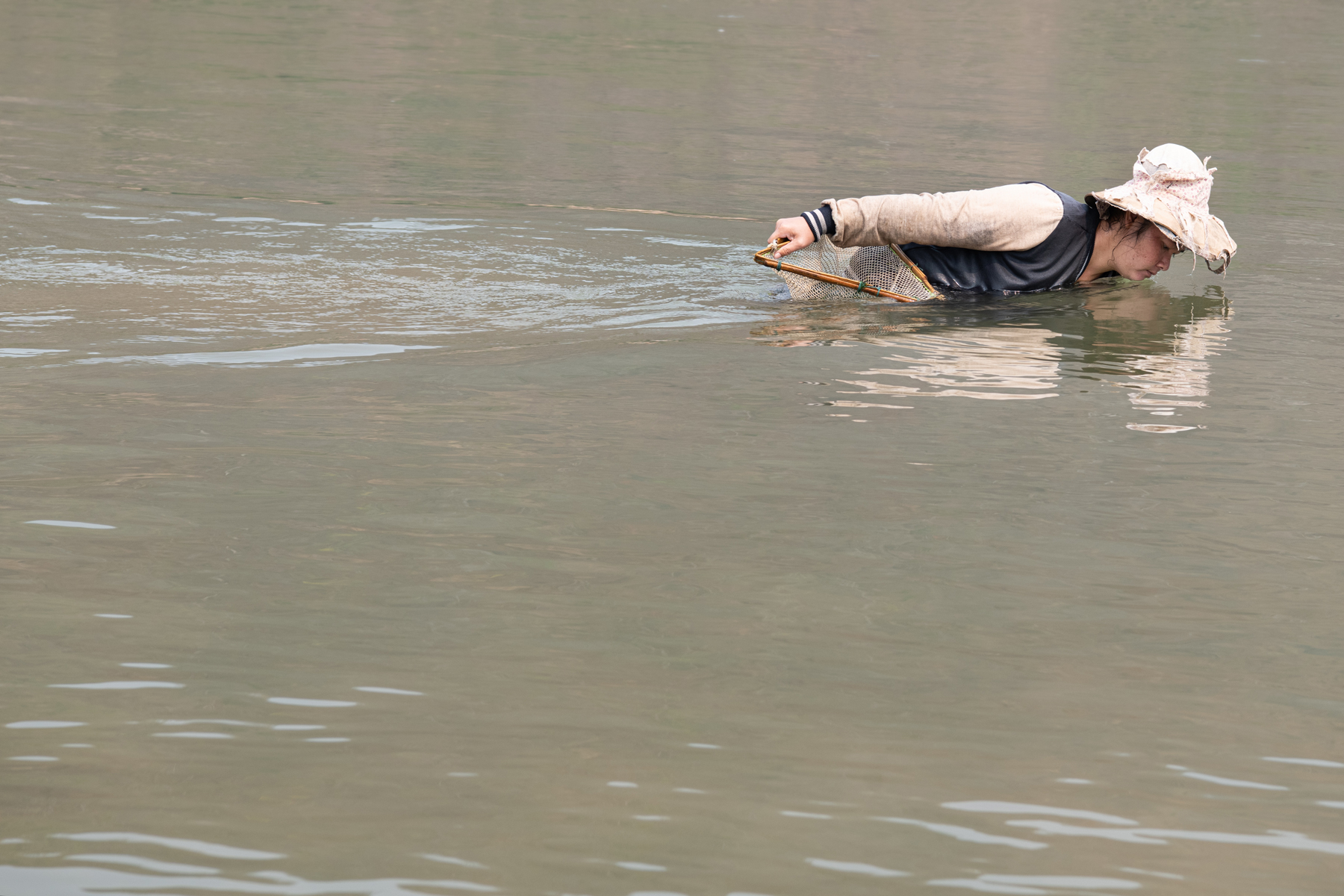 a man in a fishing net in water