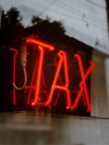 a close-up of a red lit tax sign