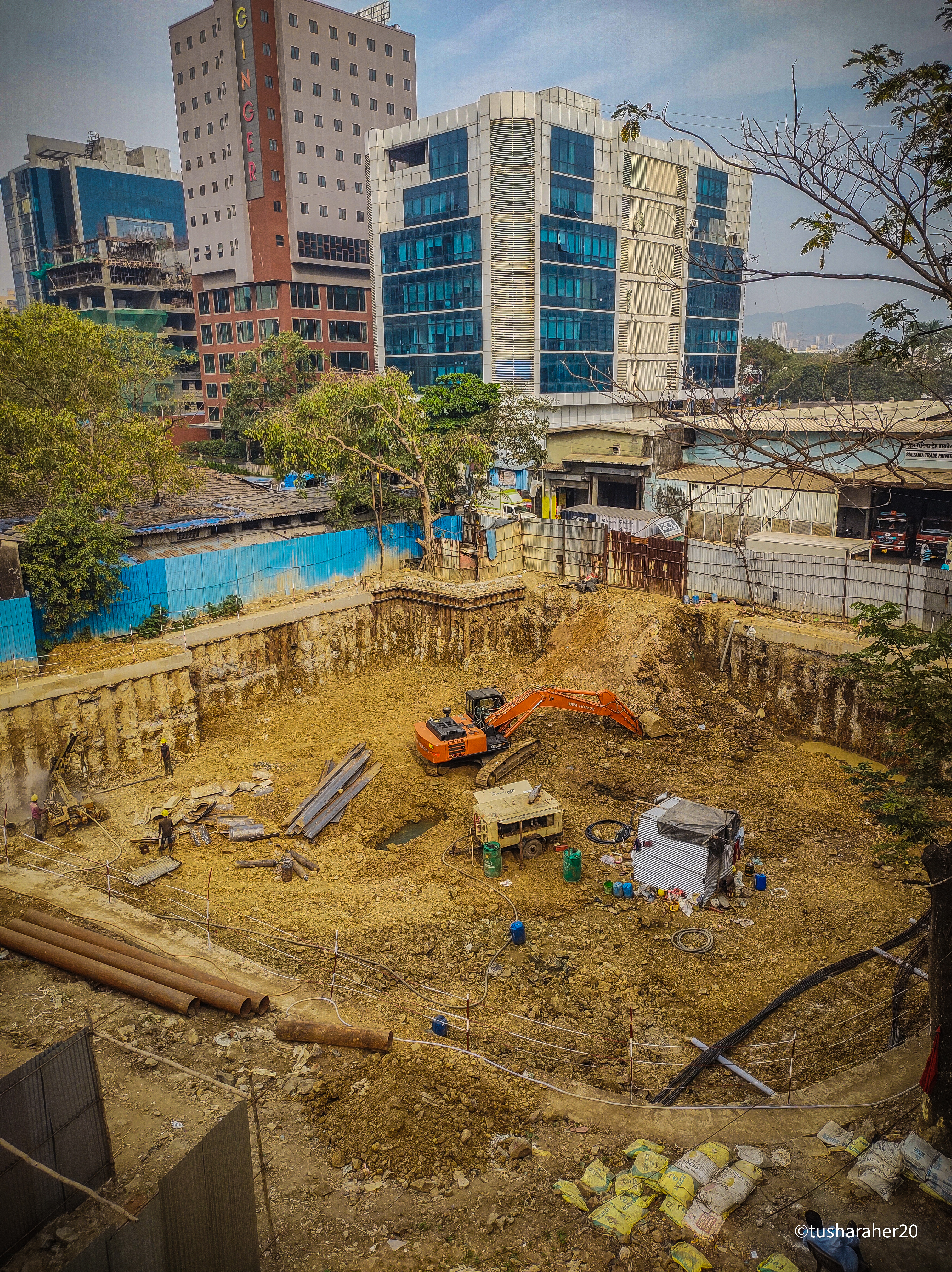 a construction site with a bulldozer and buildings in the background