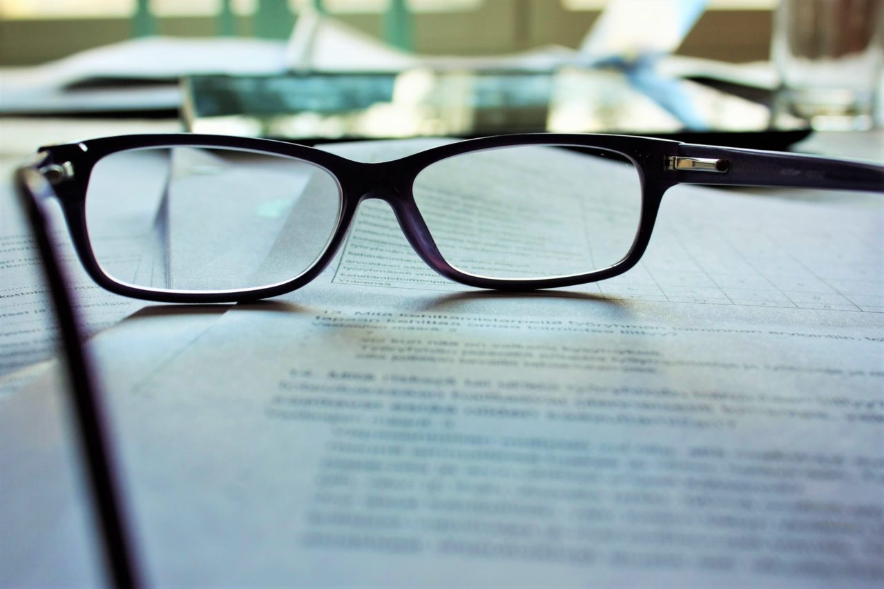 a pair of glasses on a piece of paper