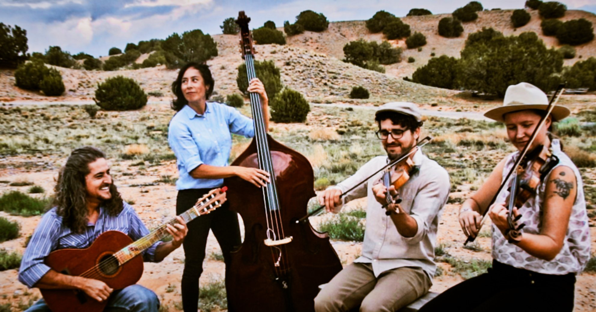 a group of people playing instruments in a field
