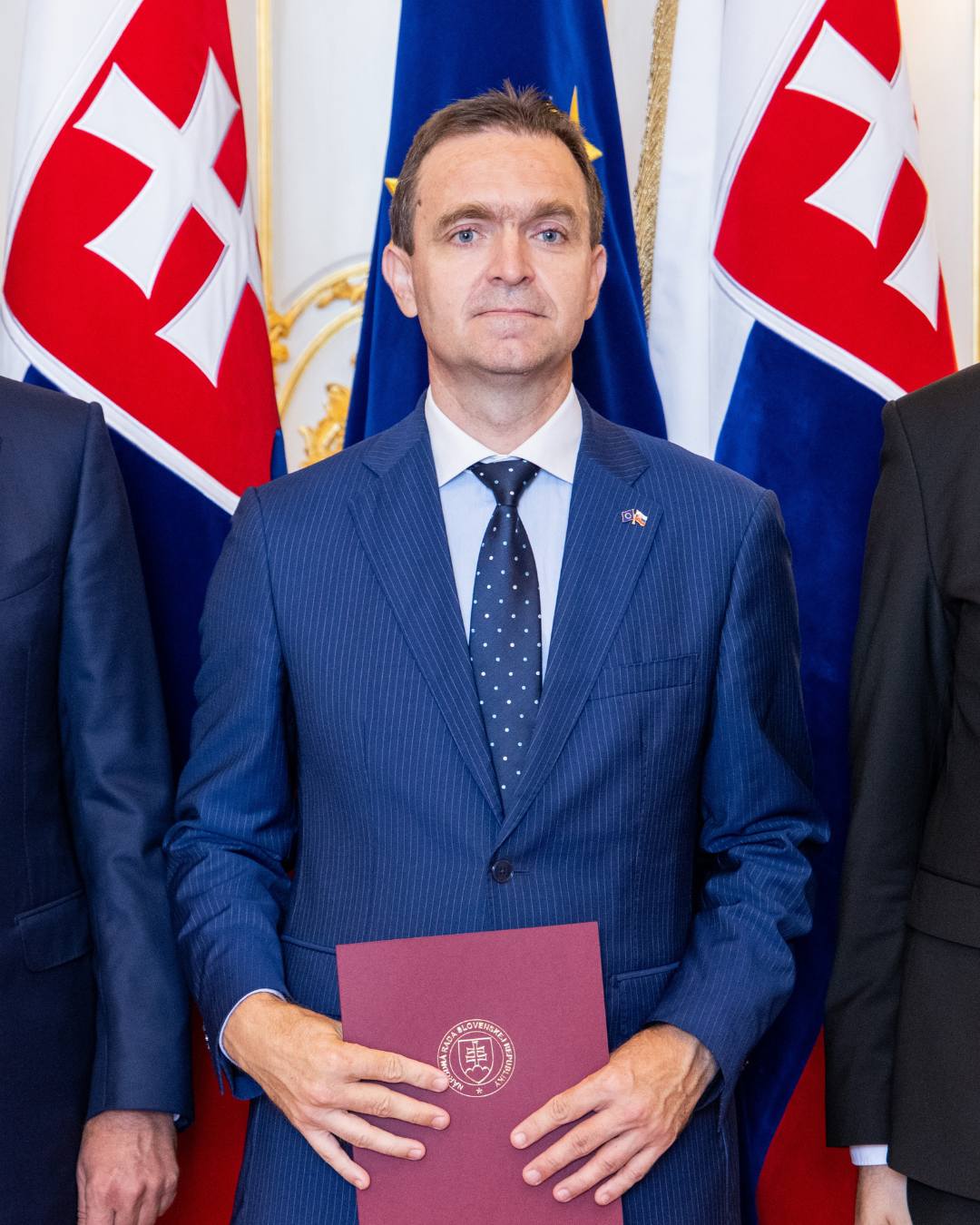 a man in a suit holding a document