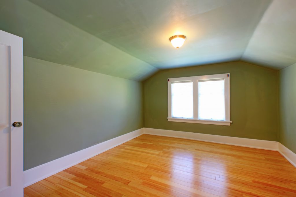 a room with a wood floor and a light fixture