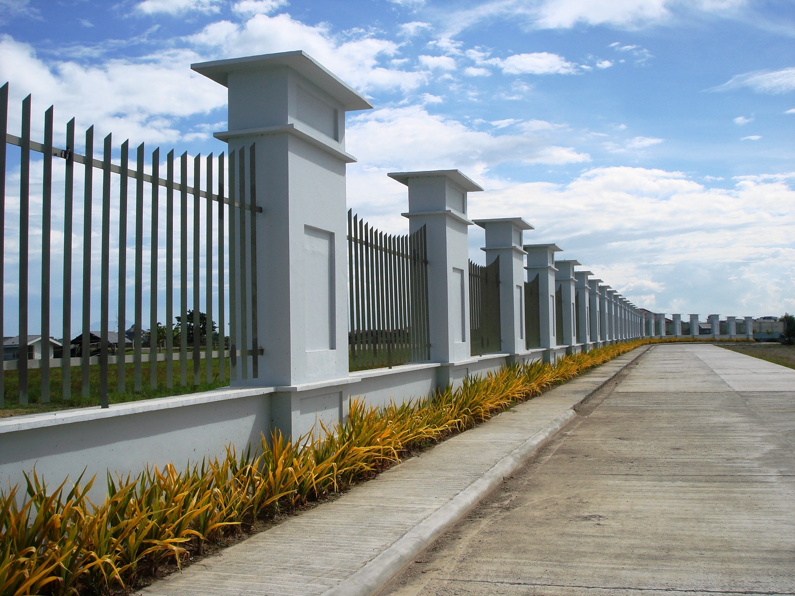 a fence with pillars and grass