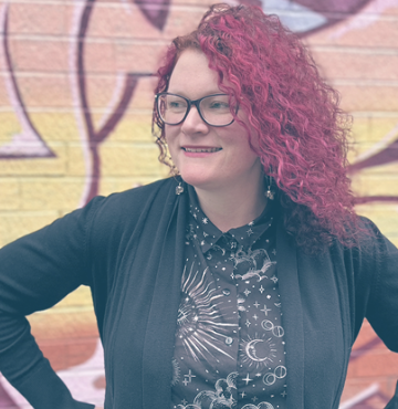 a woman with red hair and glasses