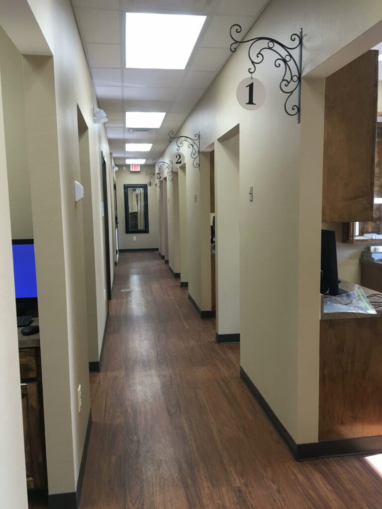 a hallway with a wood floor and a wood floor