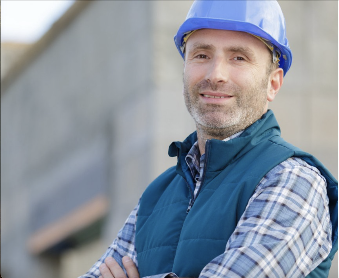 a man wearing a blue hard hat and vest