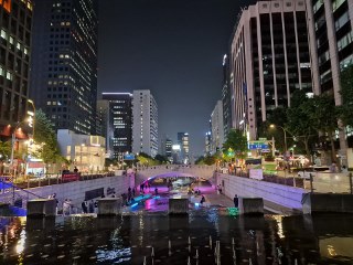 a city at night with buildings and a bridge