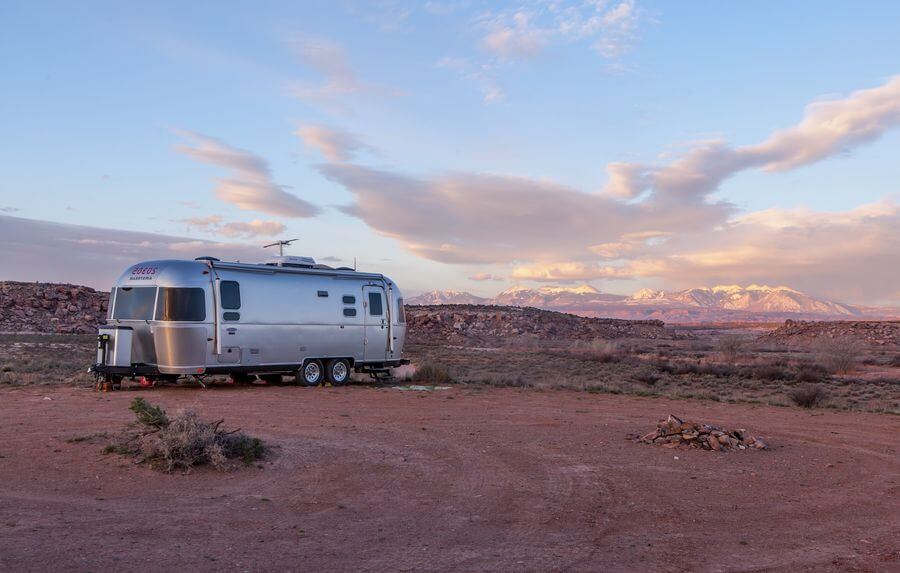 a silver trailer in a desert