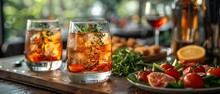 a glass of liquid with ice and a plate of food on a table