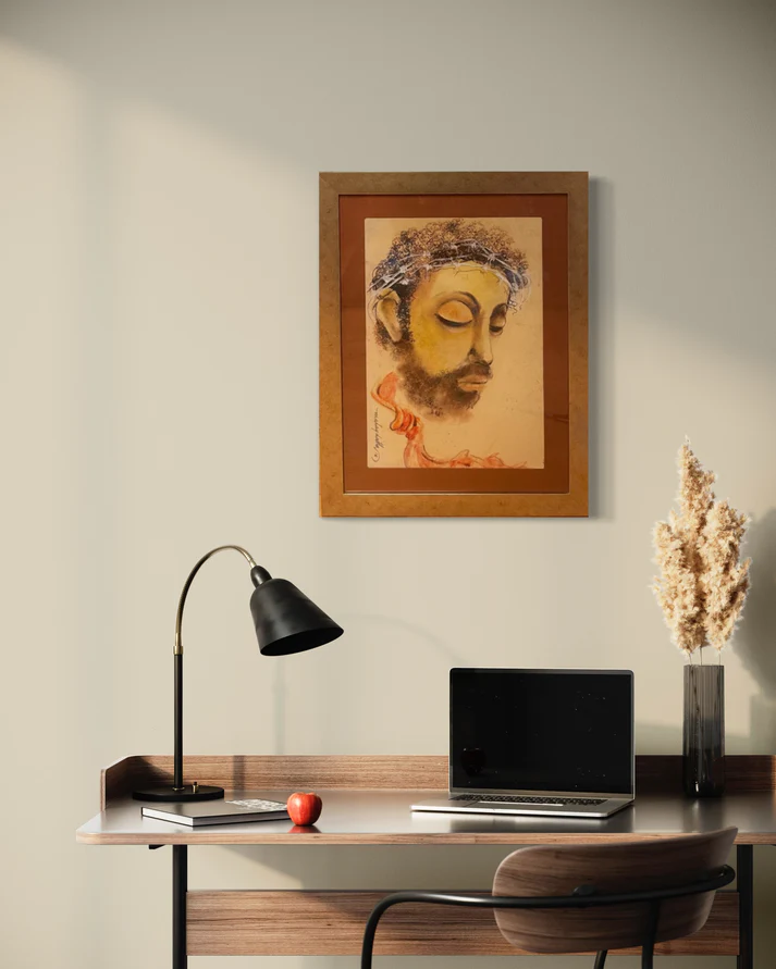 a desk with a laptop and a painting on the wall
