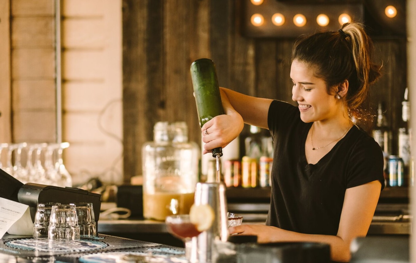 a woman holding a green bottle