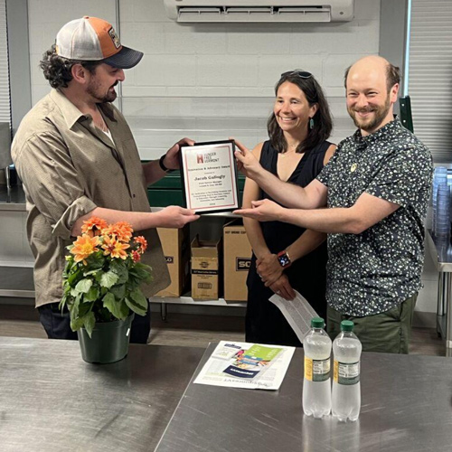 a group of people holding a certificate