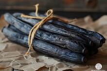 a bunch of black bananas tied with a rope