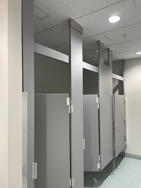 a row of grey doors in a bathroom