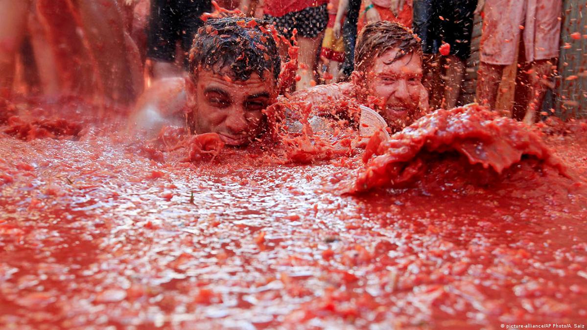 a group of people in a tomato sauce pool
