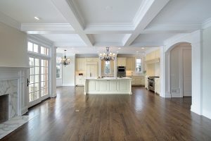 a large white kitchen with a wood floor