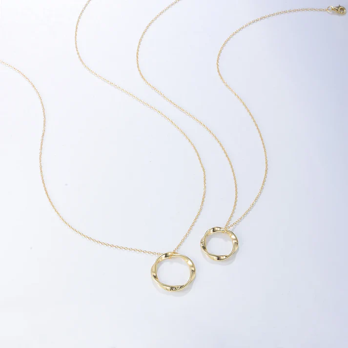 a pair of gold necklaces