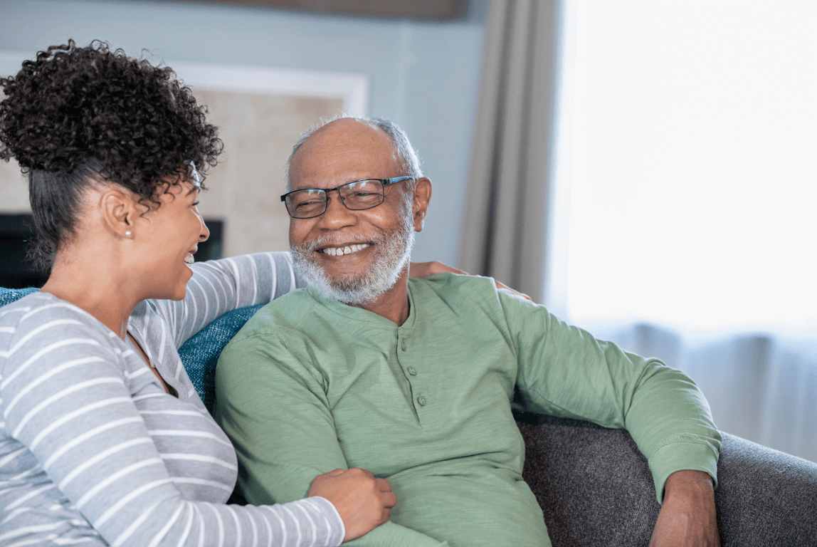 a woman and man sitting on a couch