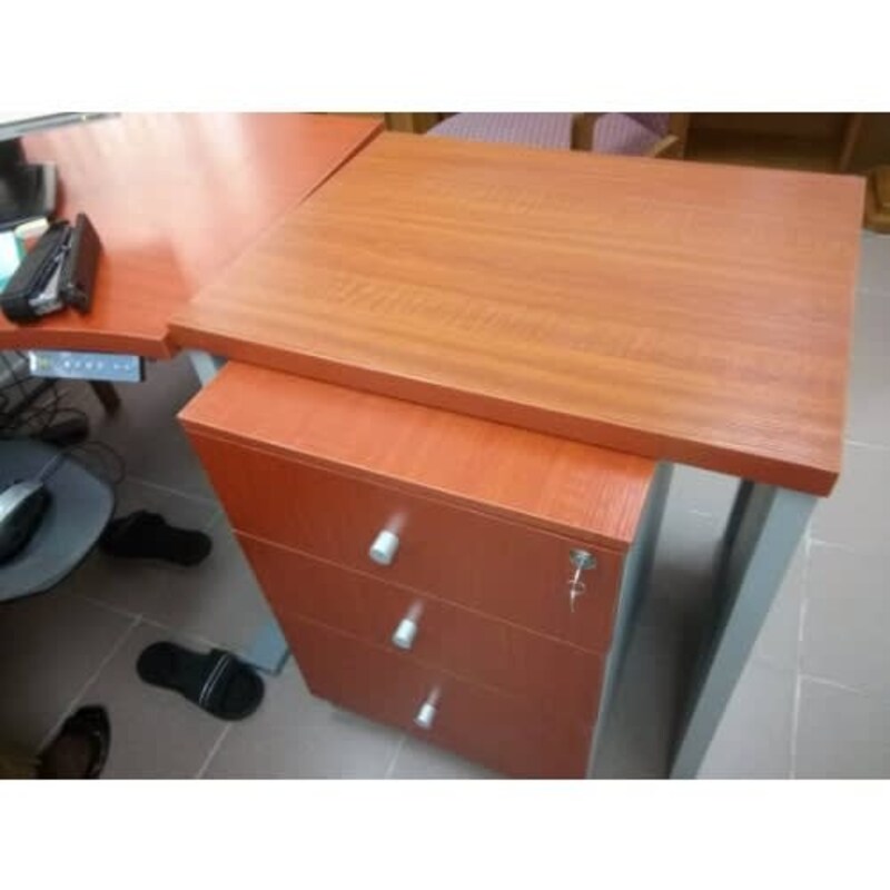 a desk with drawers and a phone on it