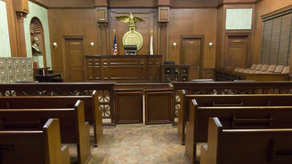 a courtroom with wooden benches