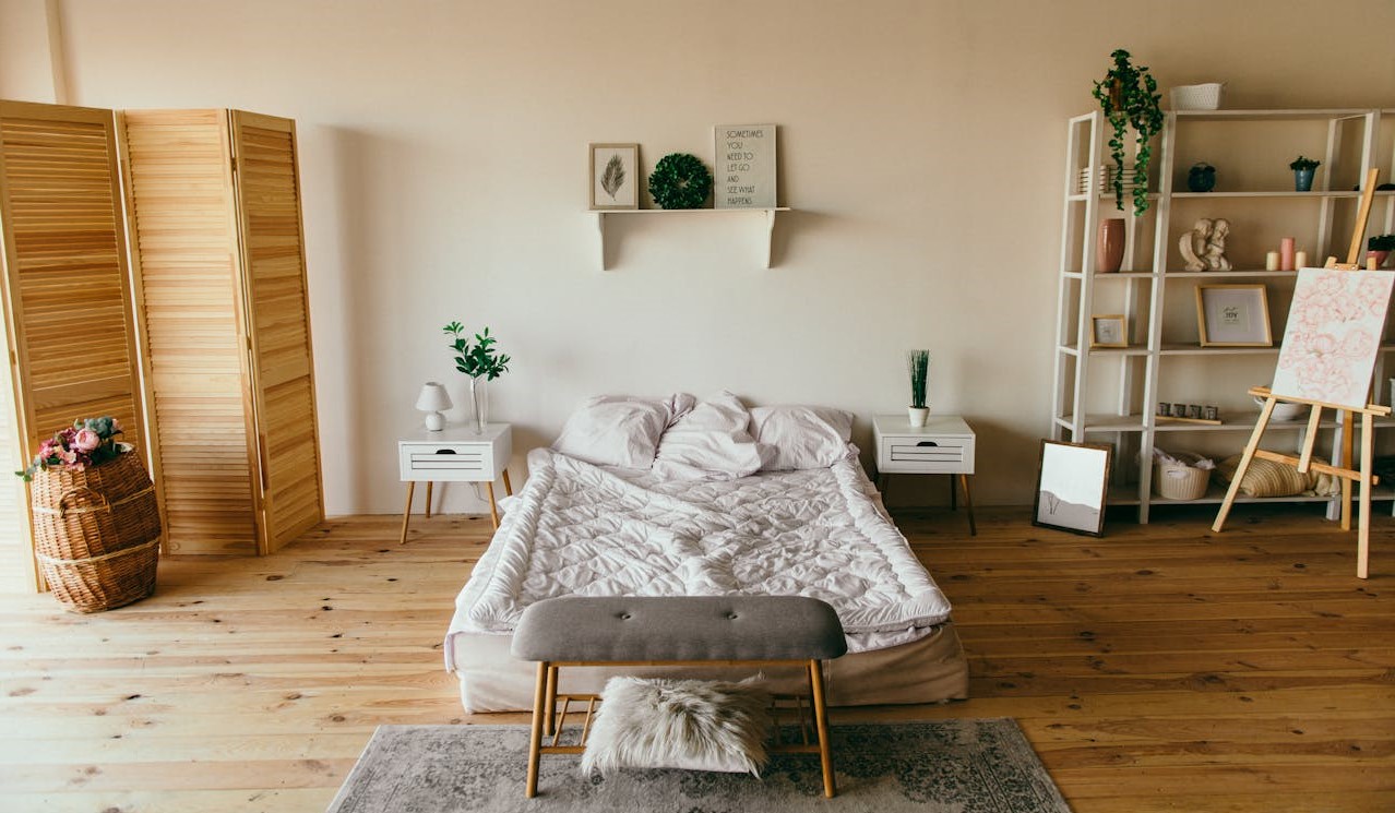 a bedroom with a bed and a bench
