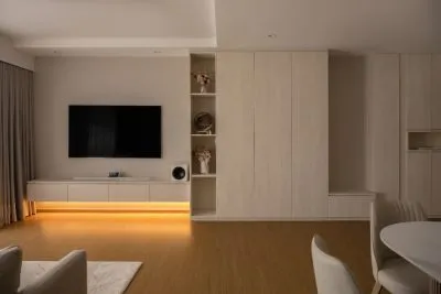 a room with a tv and shelves