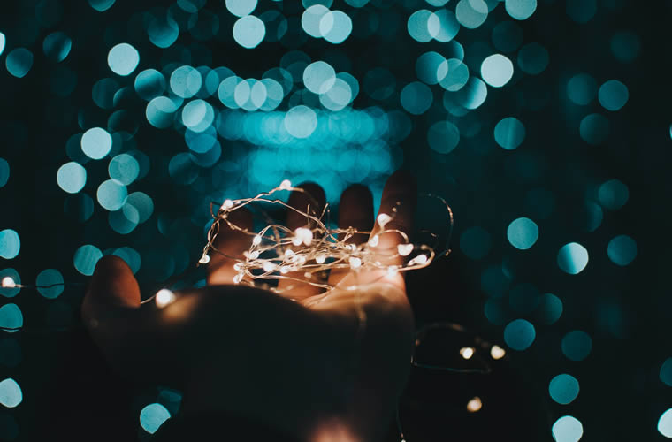 a hand holding a string of lights
