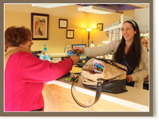 a woman handing over a purse to a customer