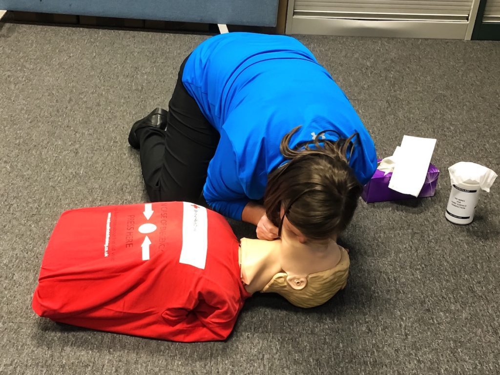a person on the ground with a dummy