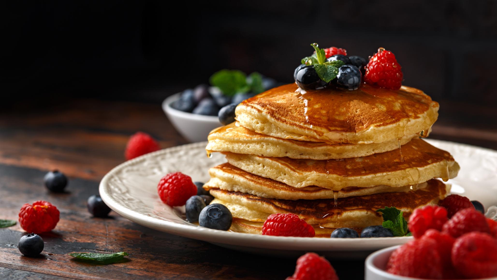 a stack of pancakes with berries on top