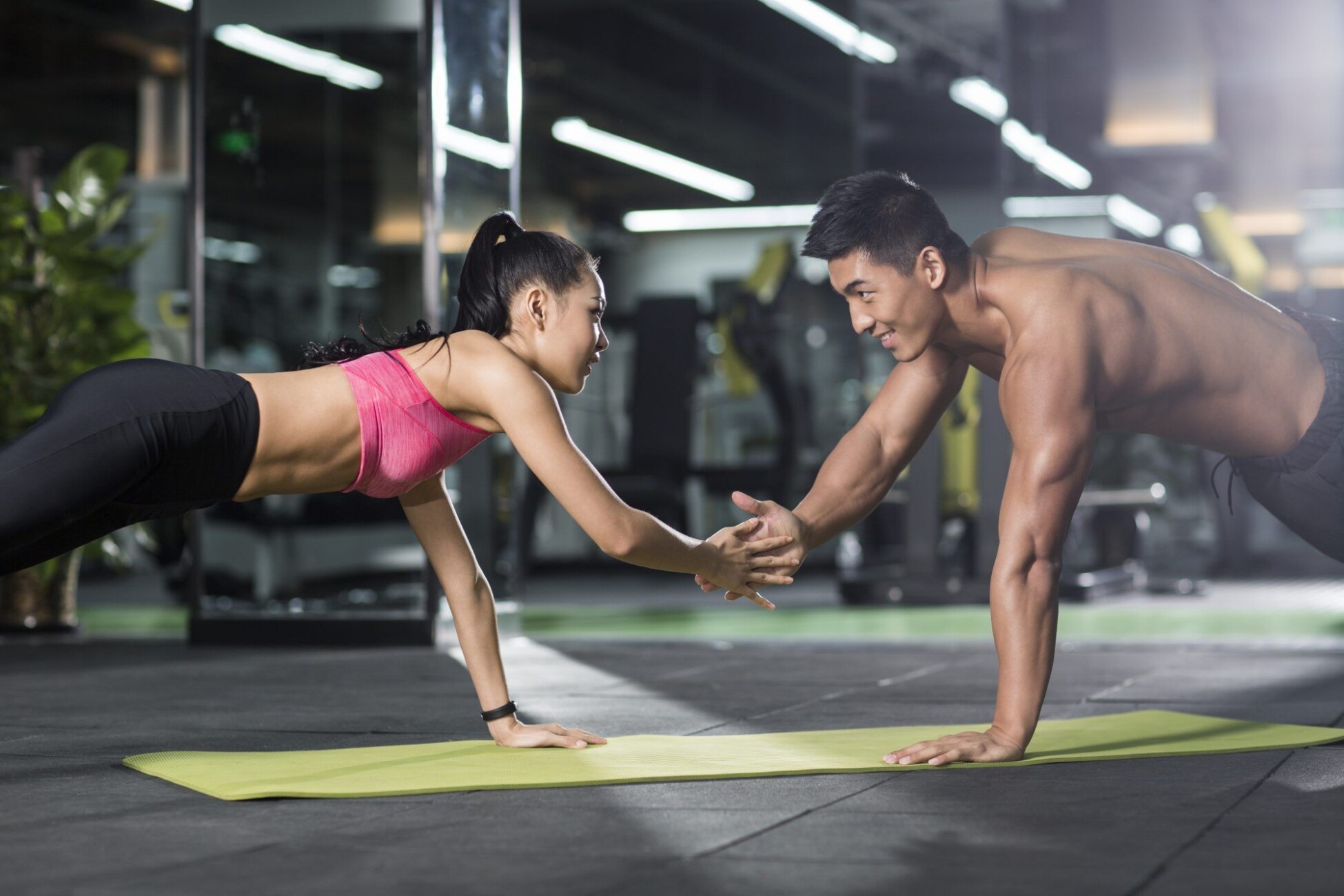 a man and woman doing push ups