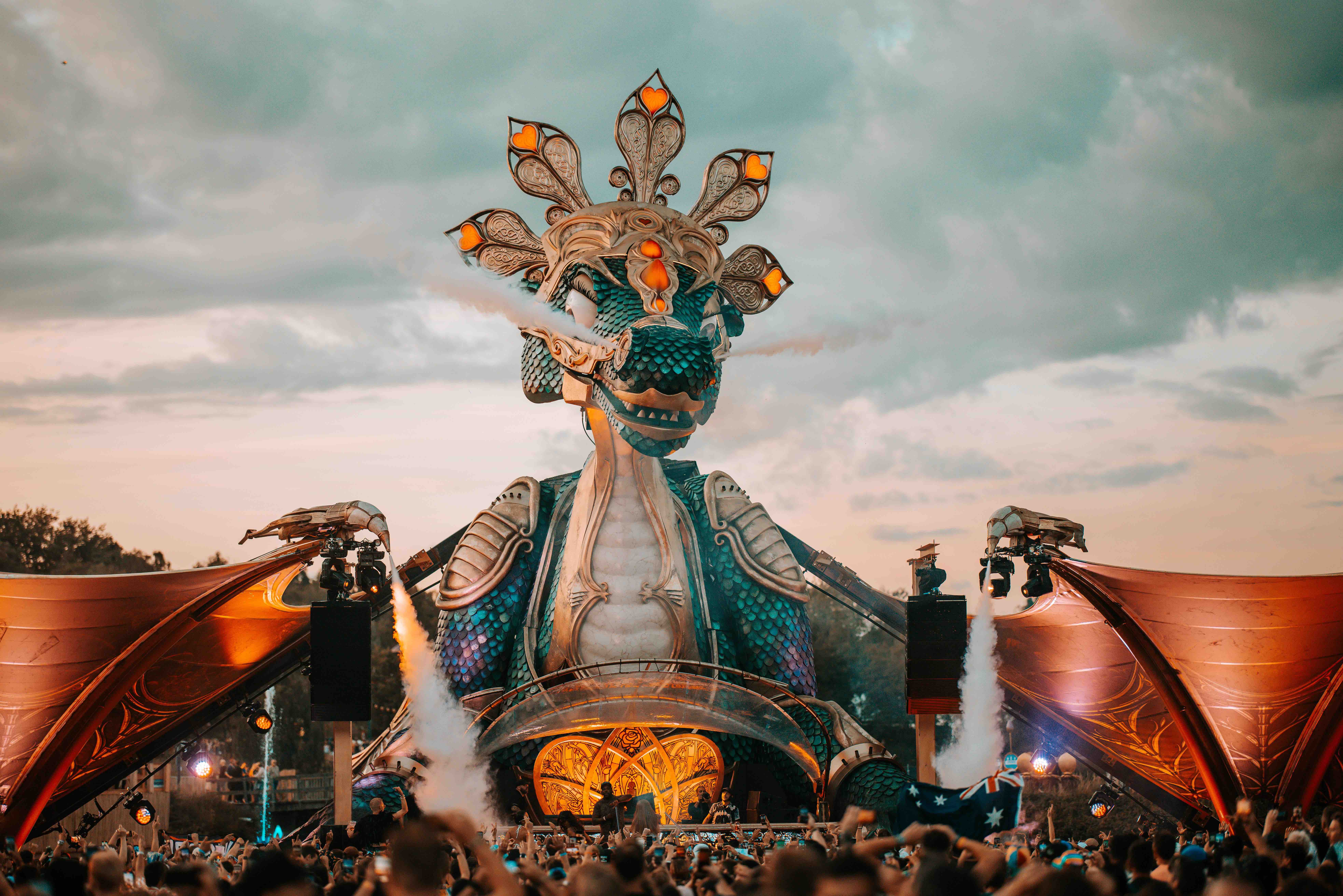 a large statue of a dragon with a crowd of people around it