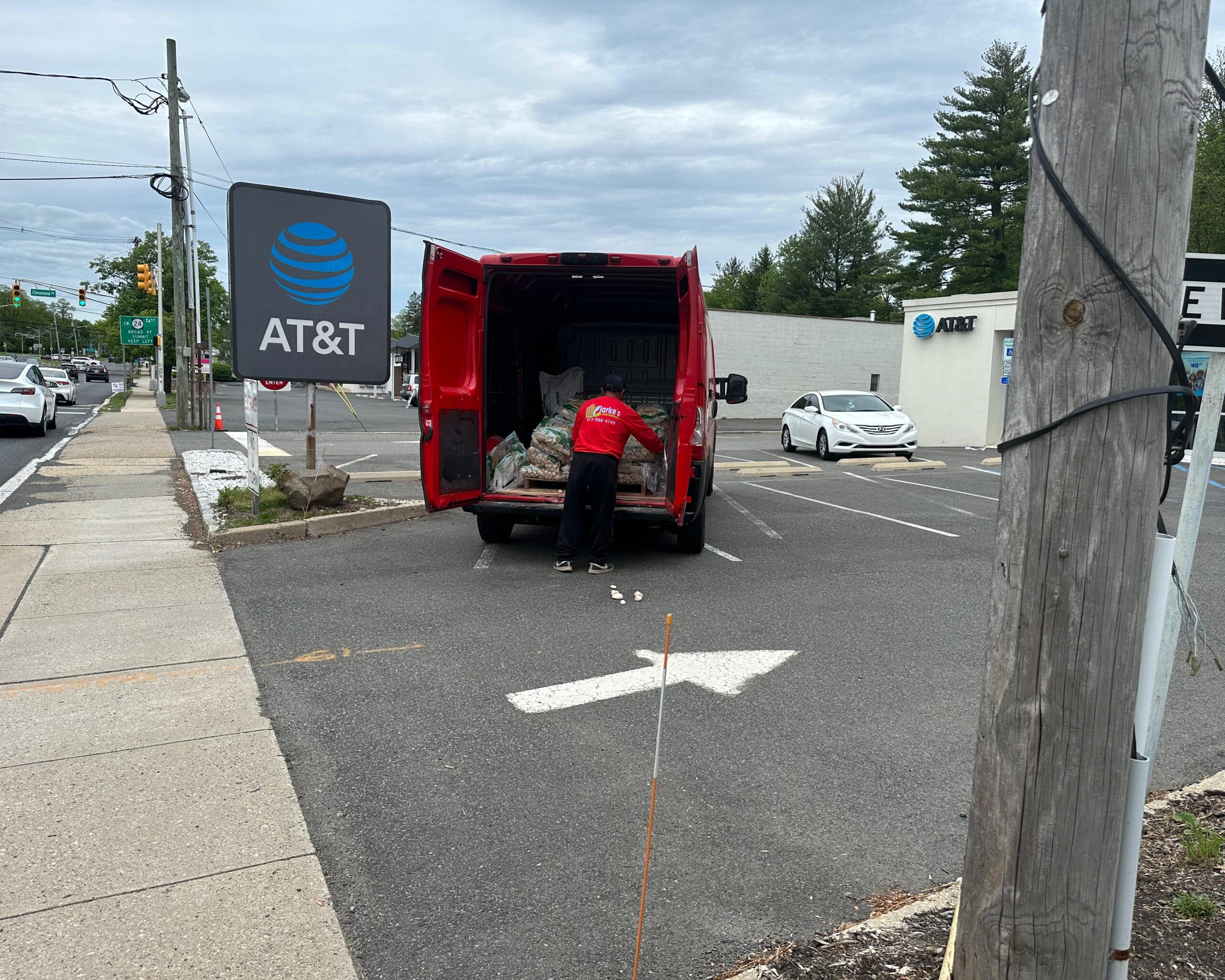 a person in a red shirt unloading a van