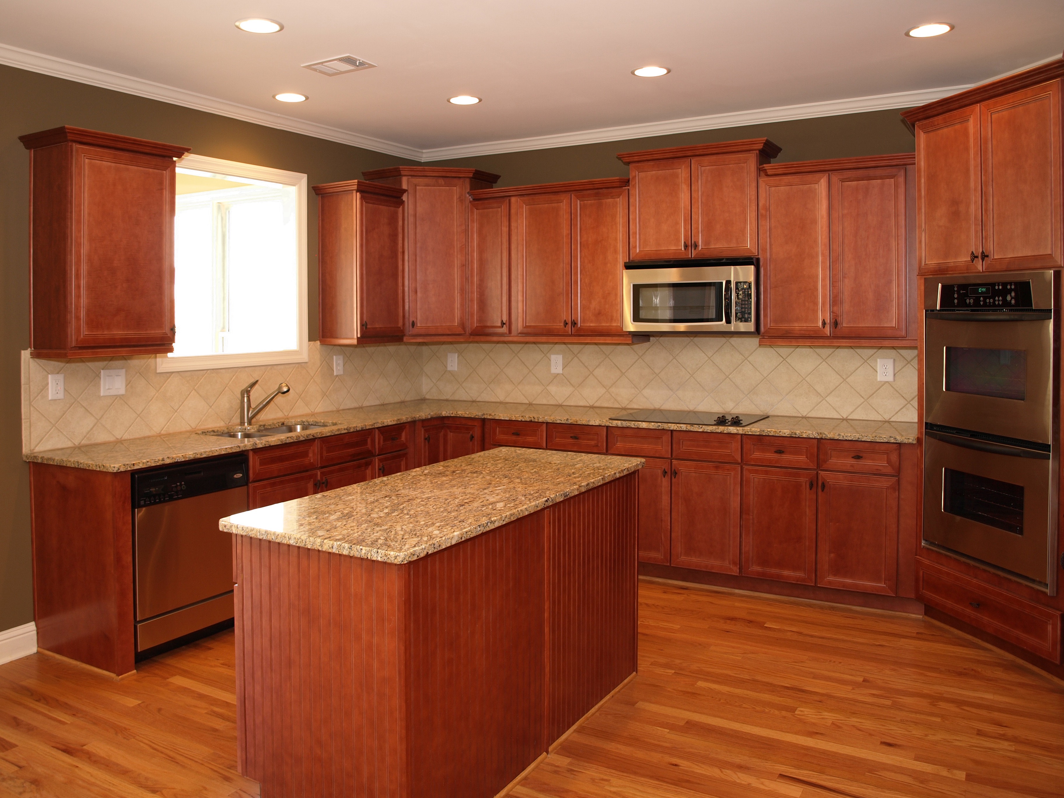 a kitchen with wood cabinets and a counter top