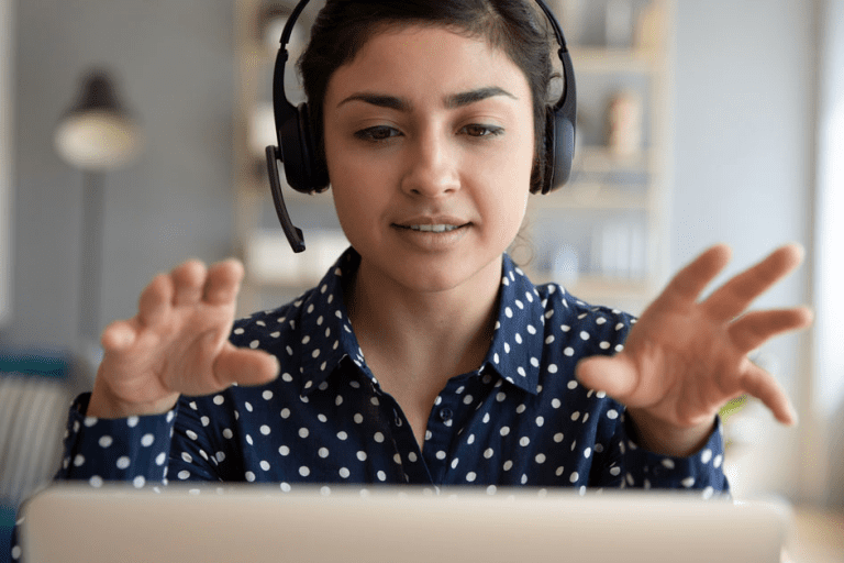 a woman wearing headphones looking at a computer screen
