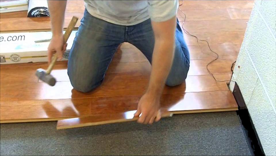 a man kneeling on a floor