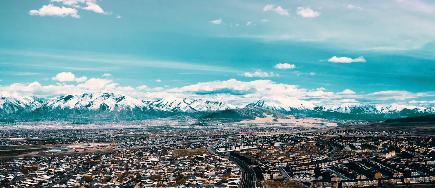 a city with snow covered mountains in the background