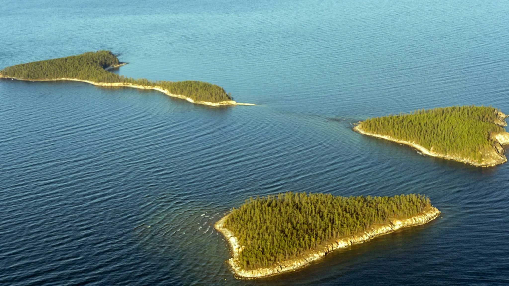 an aerial view of small islands in the water