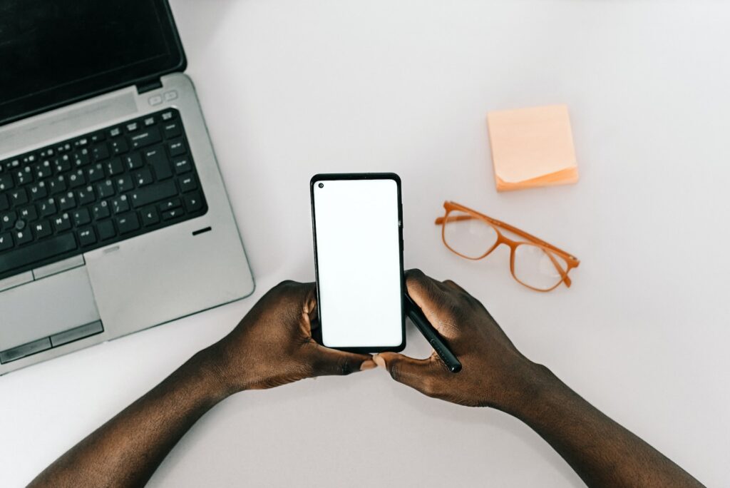 a person holding a phone and a stylus