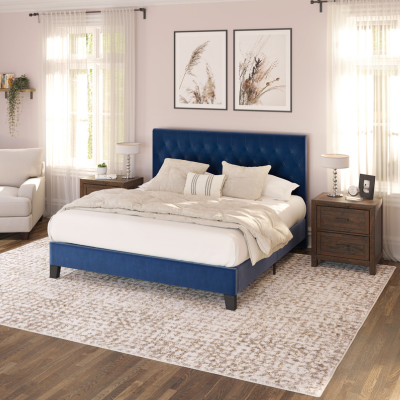 a bedroom with a blue bed and white furniture