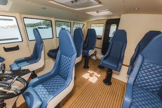 a row of blue chairs on a boat