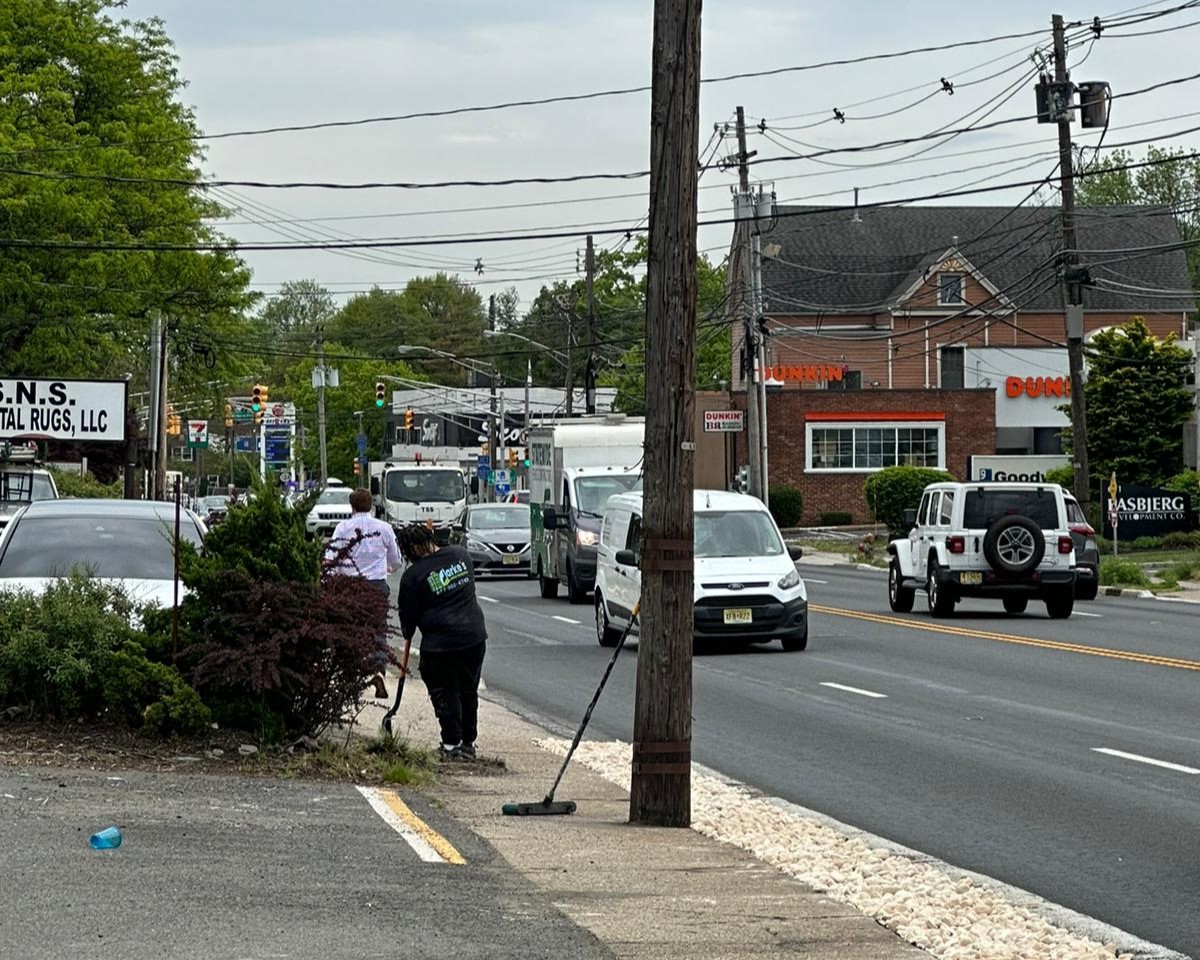 a group of people cleaning the street