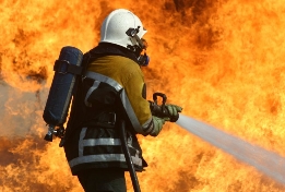 a firefighter spraying water on a fire