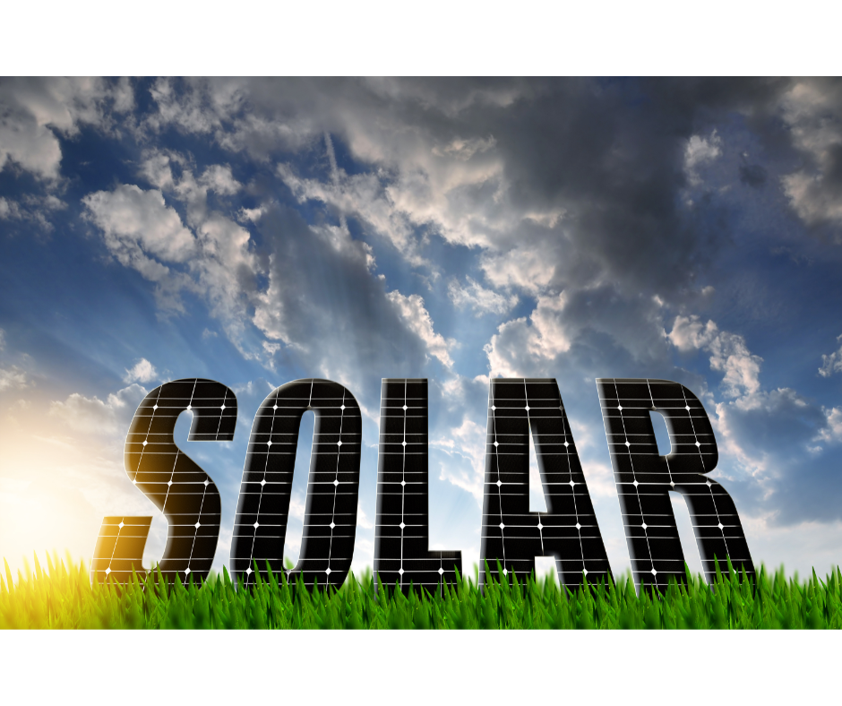 solar panels on grass with sun and clouds in the background