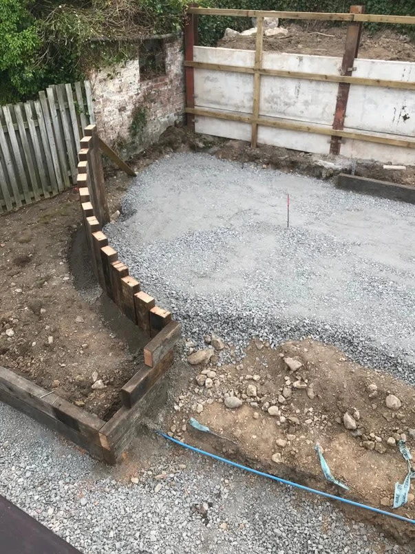 a construction site with a fence and gravel