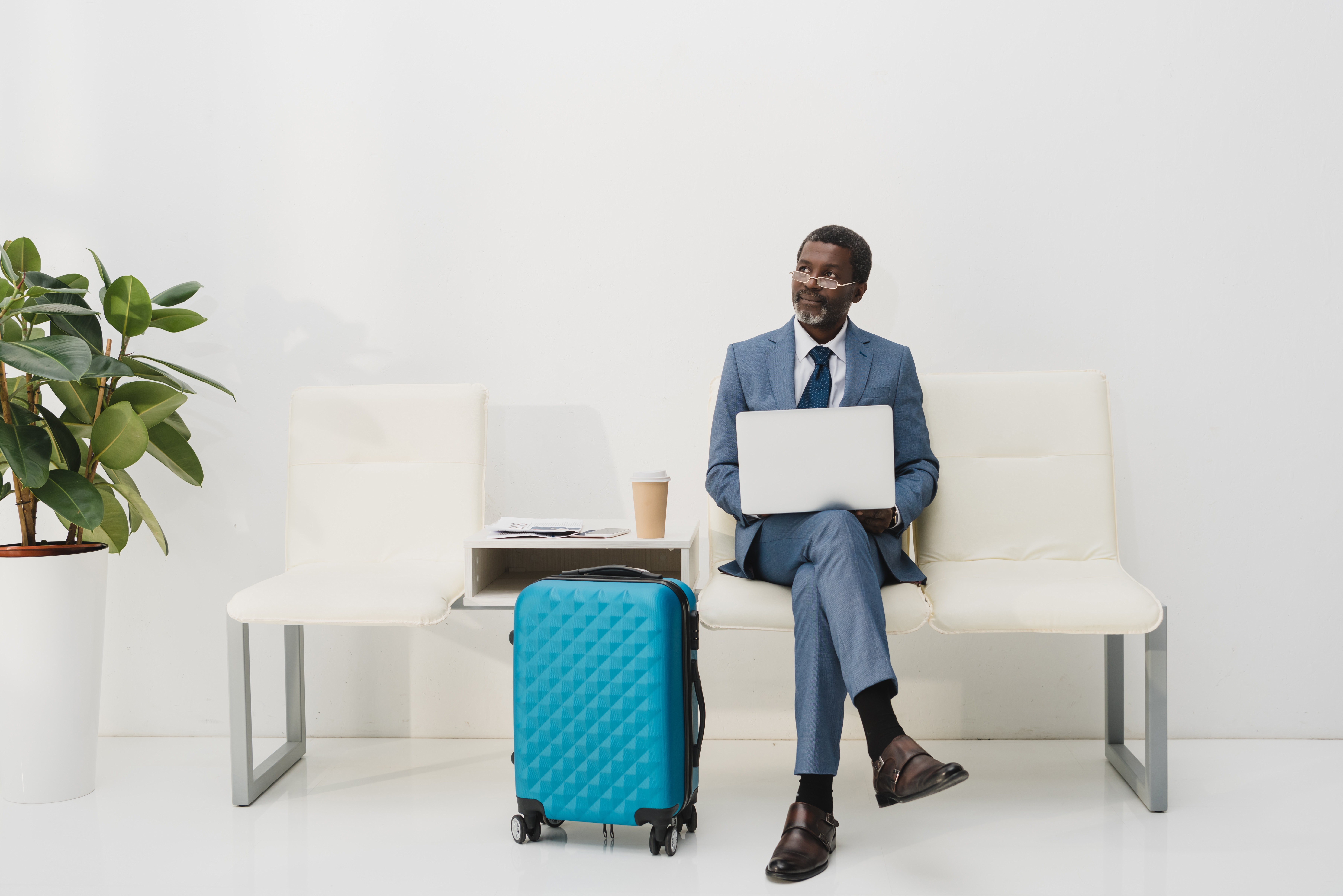 a man sitting on a chair with a laptop