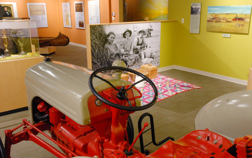 a red and white tractor in a museum