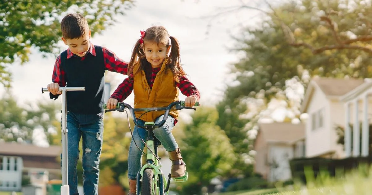 a man and girl riding a bike