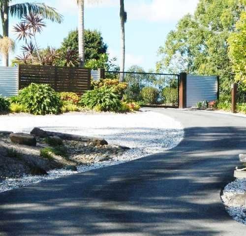 a driveway leading to a gate